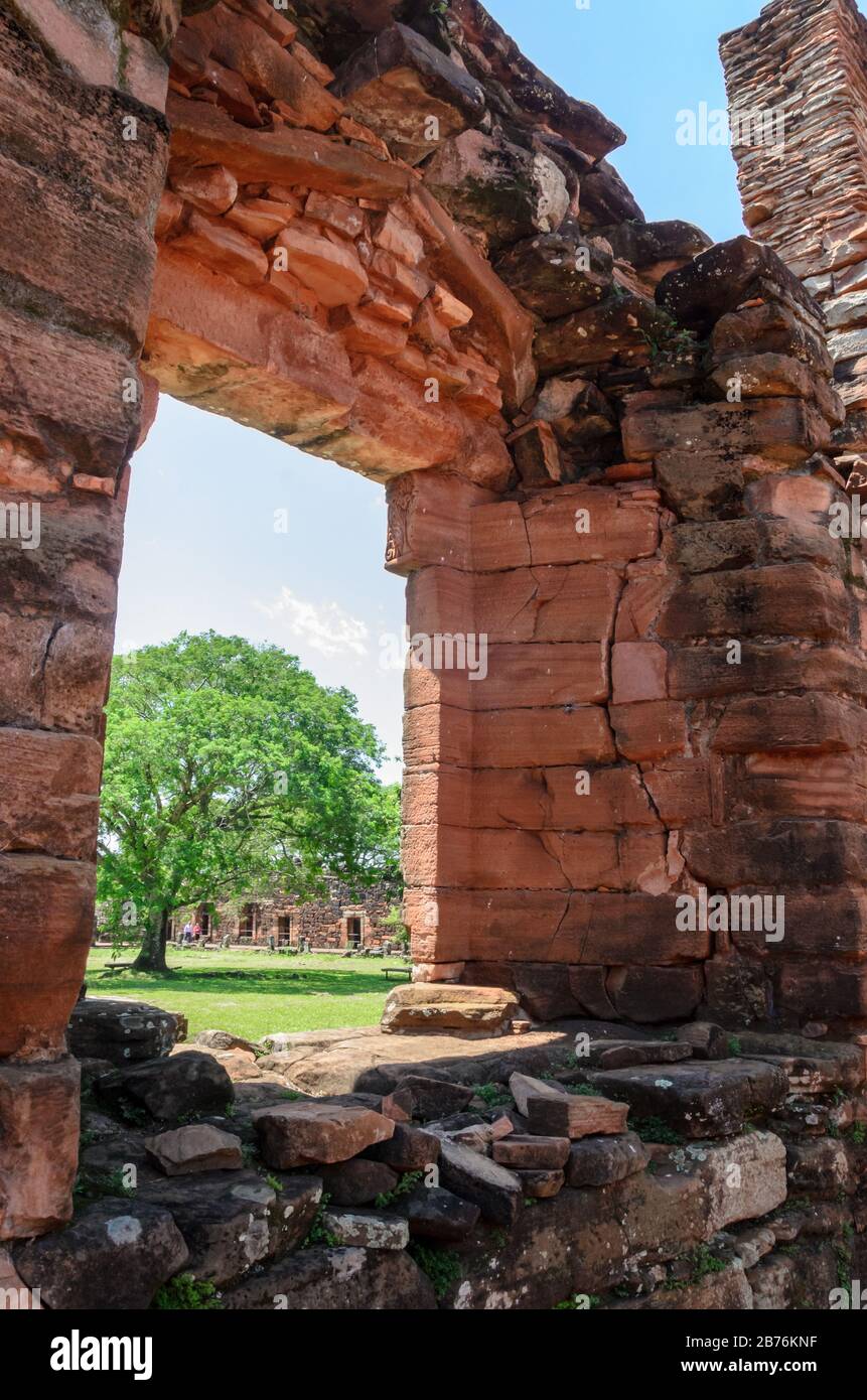 Porta di un vecchio edificio con uno sfondo di un albero e altre costruzioni in rovine di San Ignacio, Misiones, Argentina Foto Stock