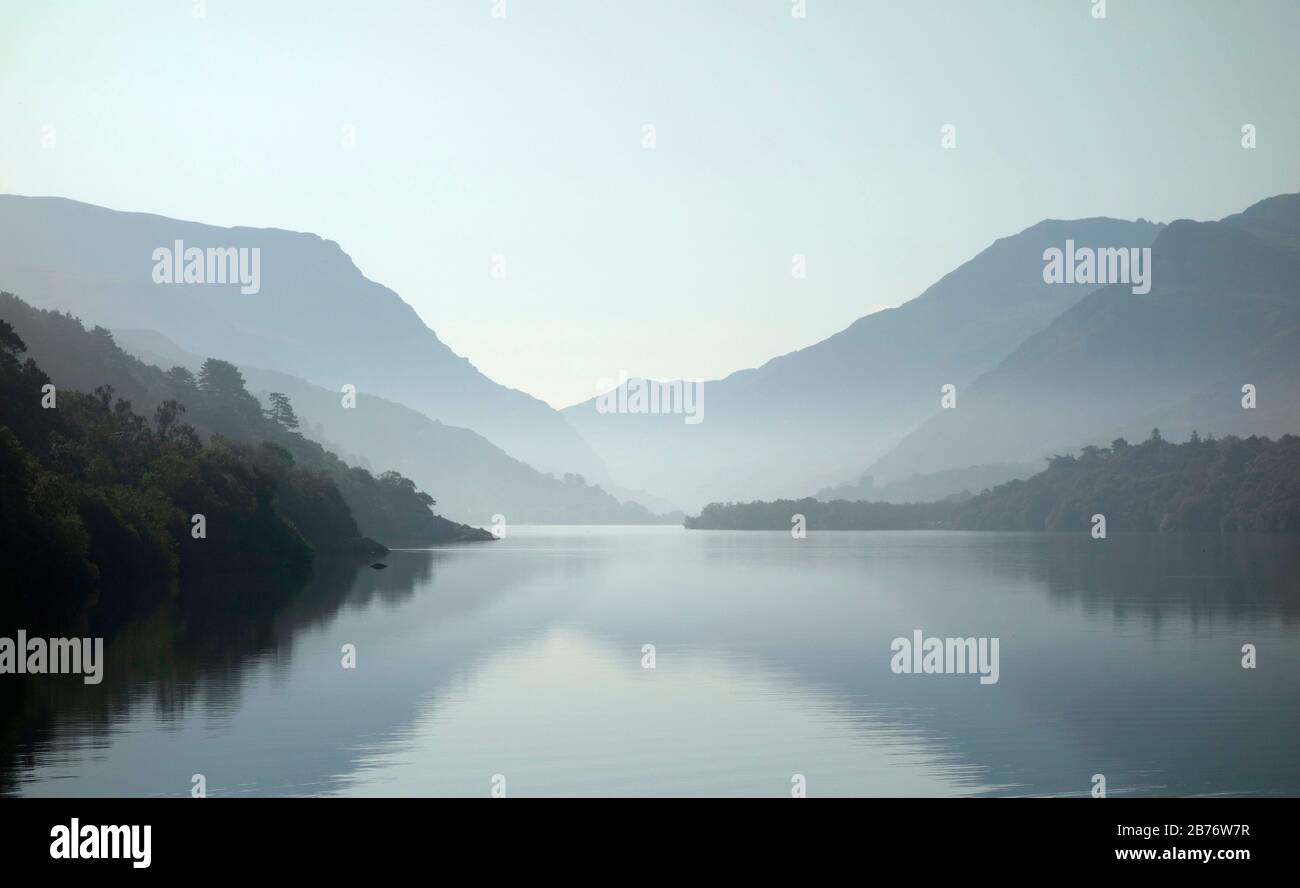 Llyn Padarn e il Llanberis Pass, Galles, Regno Unito. Llyn Padarn è un lago di forma glaciale ed è un esempio di lago maledetto morena. E' lungo circa 3.2 chilometri e profondo 29 metri, ed è uno dei più grandi laghi naturali del Galles. In lontananza si trova il Passo Llanberis, delimitato dai monti Glyderau (a sinistra) e dal massiccio dello Snowdon (a destra). Foto Stock