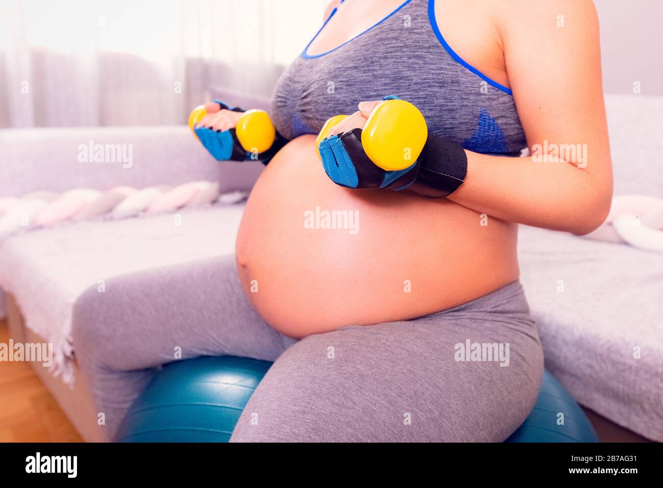 Allenamento donna incinta. Rimanere attivi durante la gravidanza, allenarsi con manubri. Foto Stock