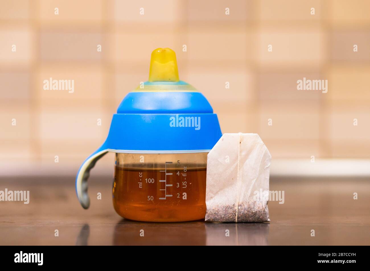 Shot di primo piano del biberon e di una borsa per il tè accanto ad esso Foto Stock