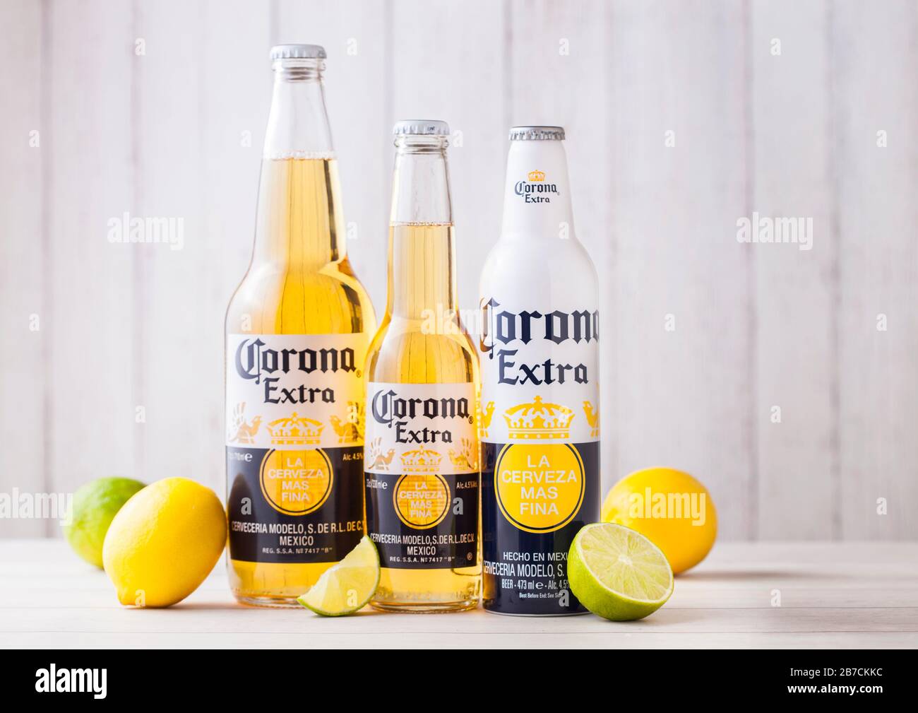 LONDON, Regno Unito - 27 Aprile 2018: bottiglie di Corona Extra birra su sfondo di legno con freschi Limoni e limette . Corona, prodotta dal Grupo Modelo. Foto Stock