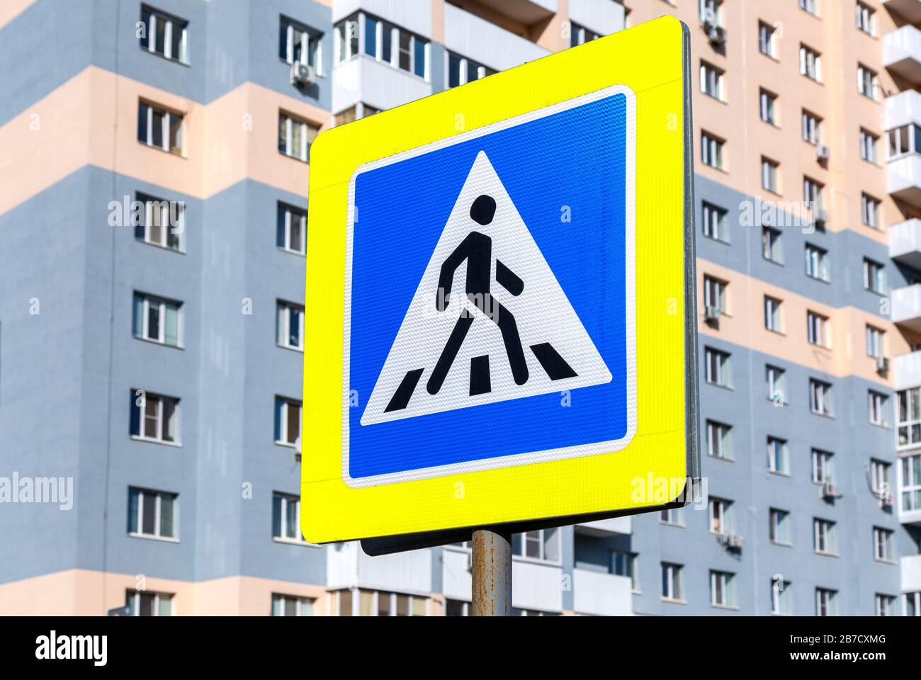 Segnaletica stradale attraversamento pedonale sullo sfondo di un edificio residenziale Foto Stock