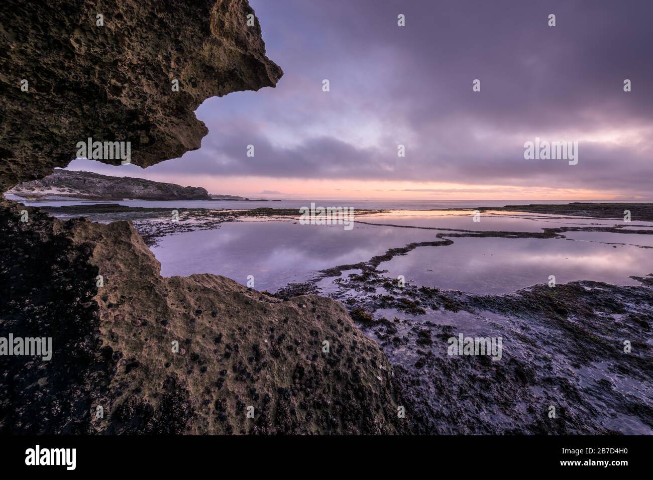 Una bella stagione di prima serata fotografata in un giorno tempestoso dopo il tramonto ad Arniston, Sud Africa. Foto Stock