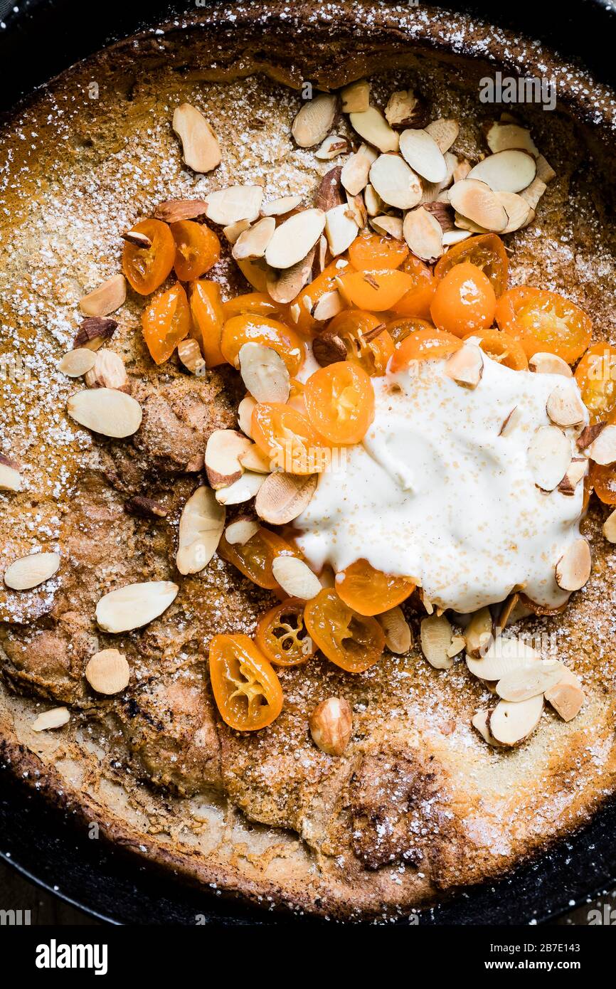 Bambina olandese di mandorle speziate alla cannella con kumquat a miele e una dollop di crème fraîche di vaniglia. Foto Stock