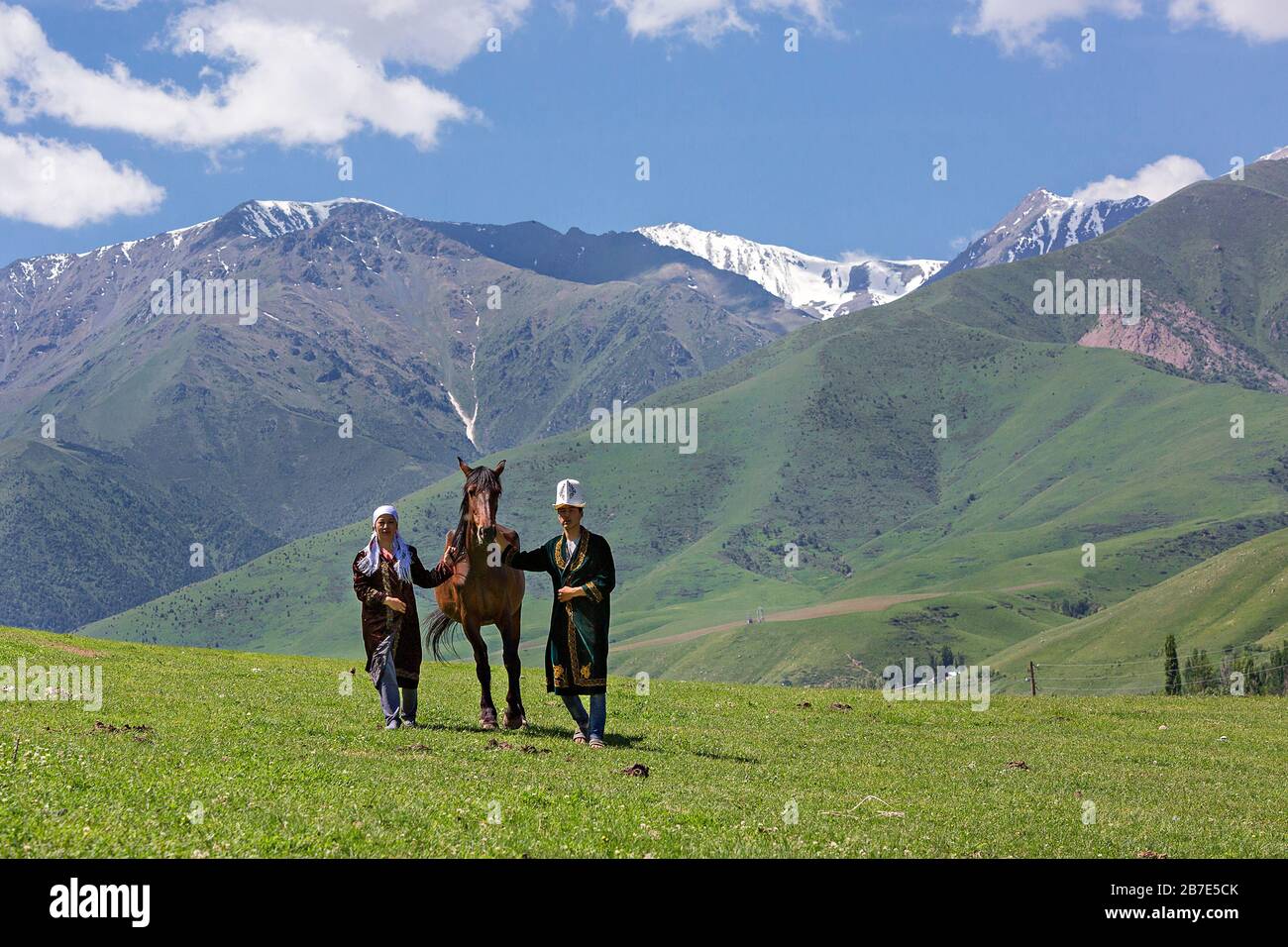 Coppia nomade e il loro cavallo nelle montagne vicino a Bishkek, Kirghizistan Foto Stock