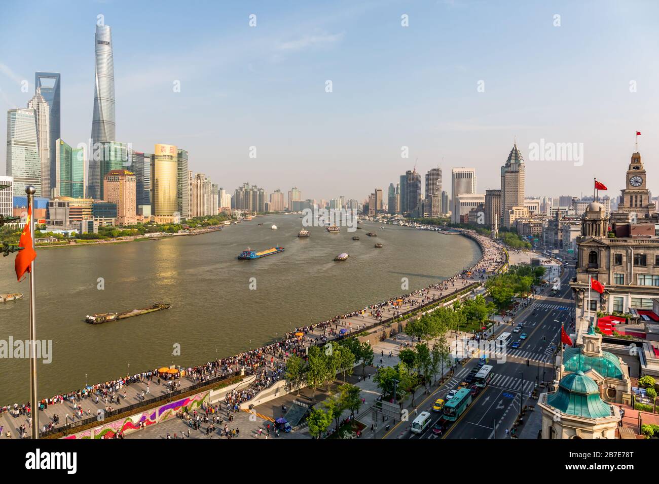 Vista sul fiume Huangpu. Sulla destra Puxi con lo storico Bund, sulla sinistra Pudong con la Shanghai Tower. Navi da carico che consegnano merci. Foto Stock