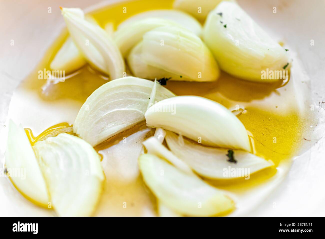 Padella con cipolle bianche tritate scalogno verdure macro primo piano cottura in olio d'oliva in cucina che mostra la consistenza Foto Stock