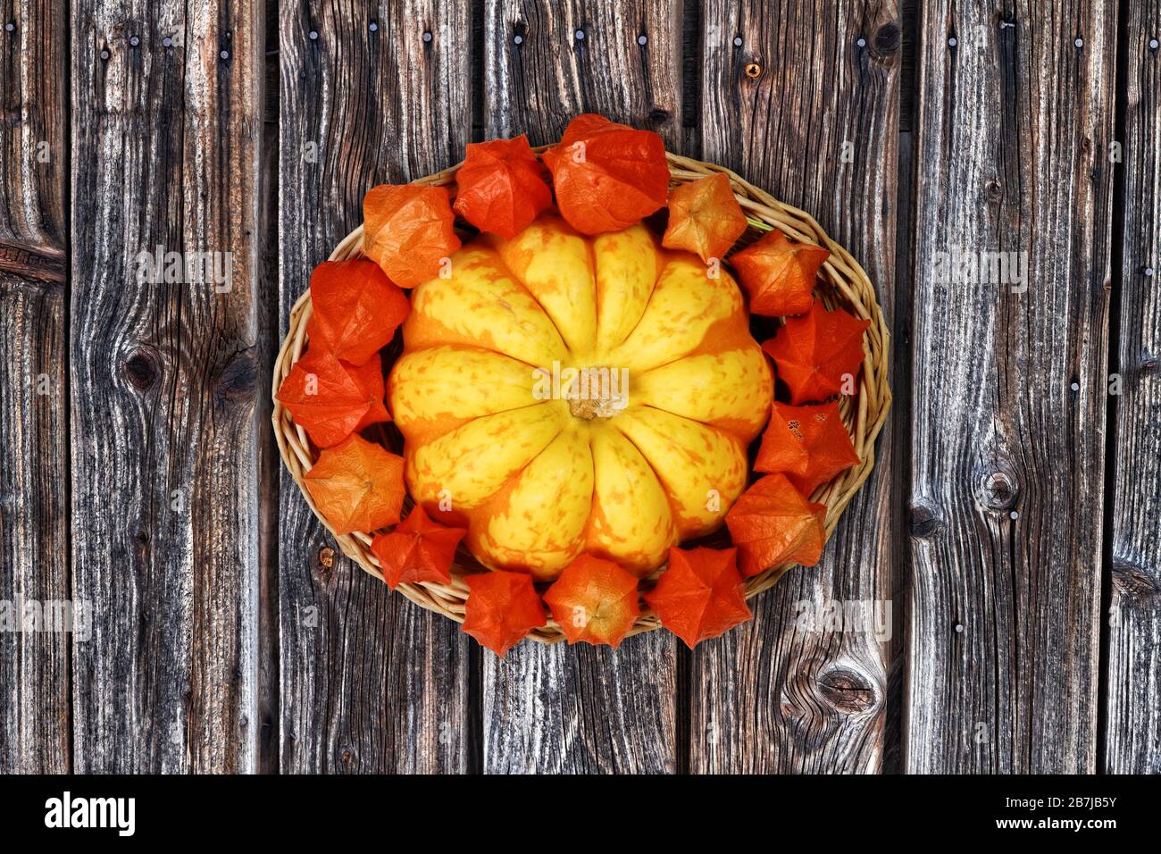 Cestino autunnale con Gourd decorativo e Physalis su sfondo di legno Foto Stock