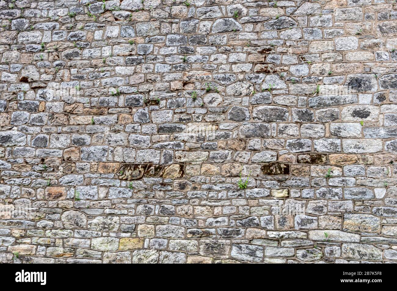 Parete di fondo piatta in pietra, fatta da blocchi di pietra di dimensioni irregolari a Eastern state Penitentiary, Philadelphia, Pennsylvania sfondo, carta da parati Foto Stock