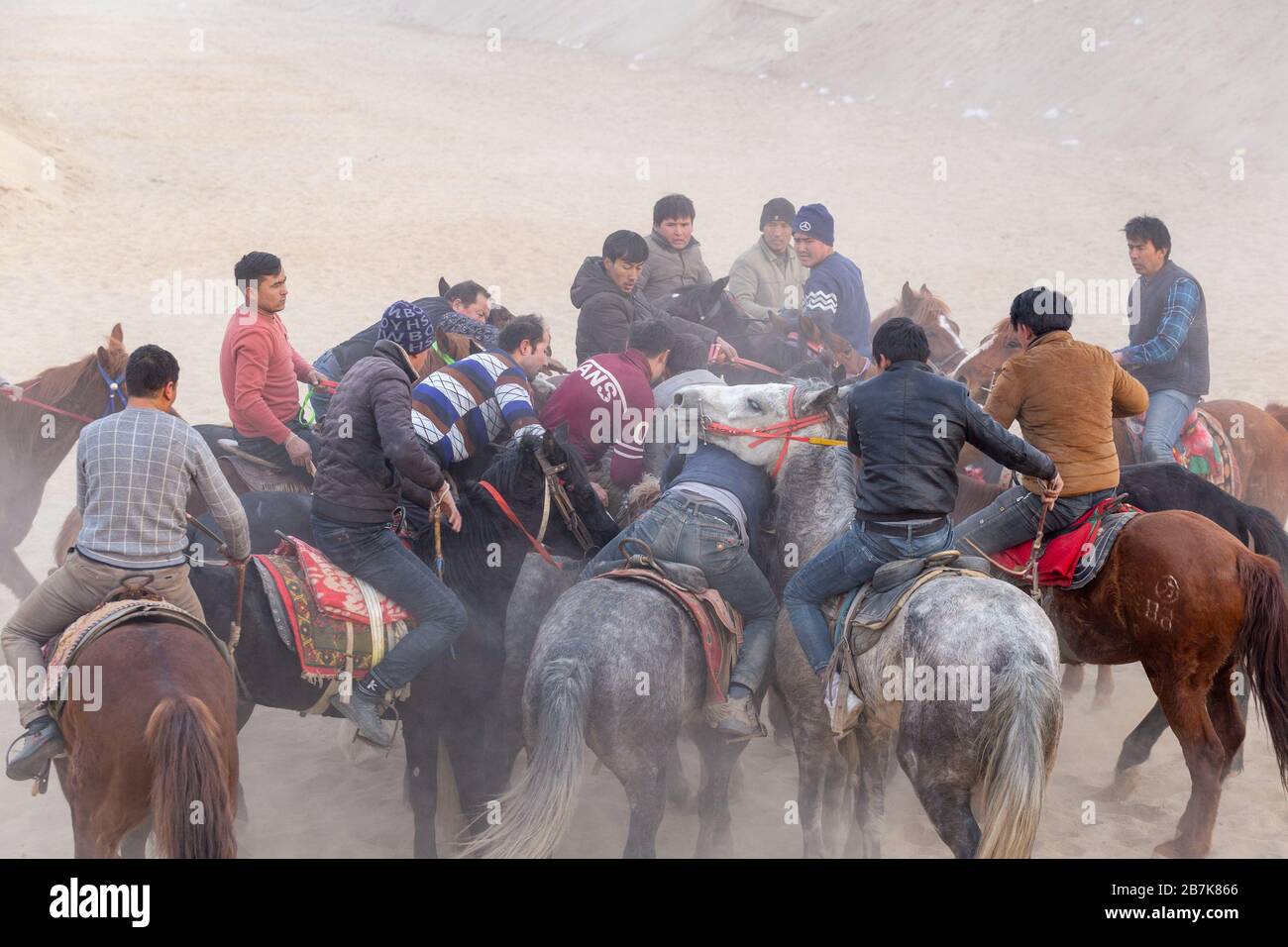 La gente cavalca i cavalli in un campo per catturare la capra nella città di Kuqa, nella regione autonoma dello Xinjiang Uyghur della Cina nord-occidentale, il 1° gennaio 2020. Persone cavalcano cavalli a Foto Stock