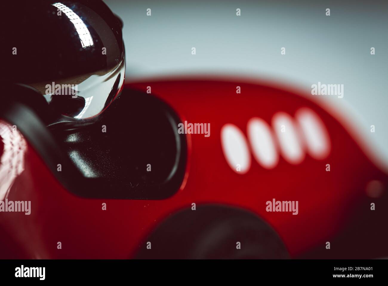 Casco luminoso in argento su un giocattolo rosso vintage auto Foto Stock