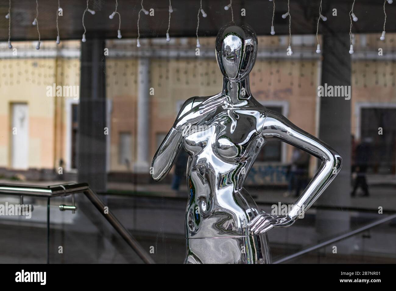 Manichino in argento in una vetrina. Vendita di cose e concetto di vendita. Foto Stock