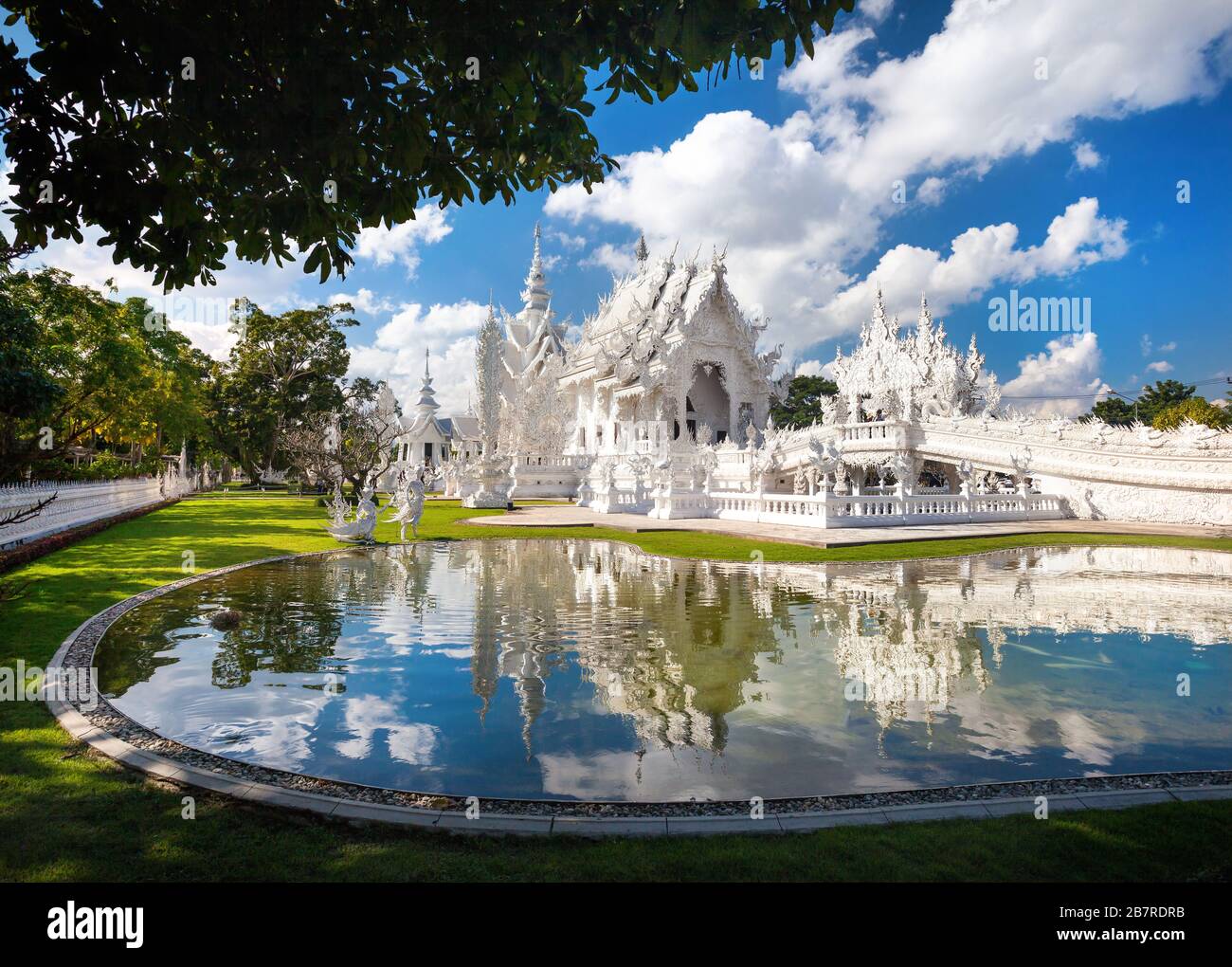 Wat Rong Khun il tempio bianco con la riflessione nello stagno in Chiang Rai, Thailandia Foto Stock