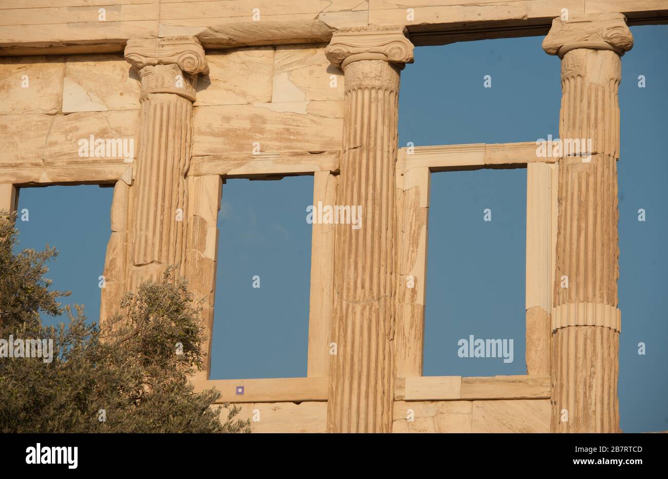 Finestre a forma rettangolare aperte contro il cielo blu tenute da pilastri in rovine architettoniche ad Atene in Grecia di giorno Foto Stock