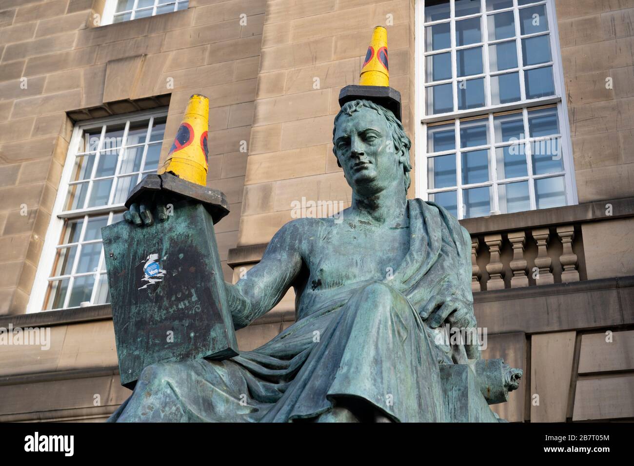 Edimburgo, Scozia, Regno Unito. 18 marzo 2020. Coni traffico posto sulla statua di David Hume sul Royal Mile di Edimburgo. Iain Masterton/Alamy Live News. Foto Stock
