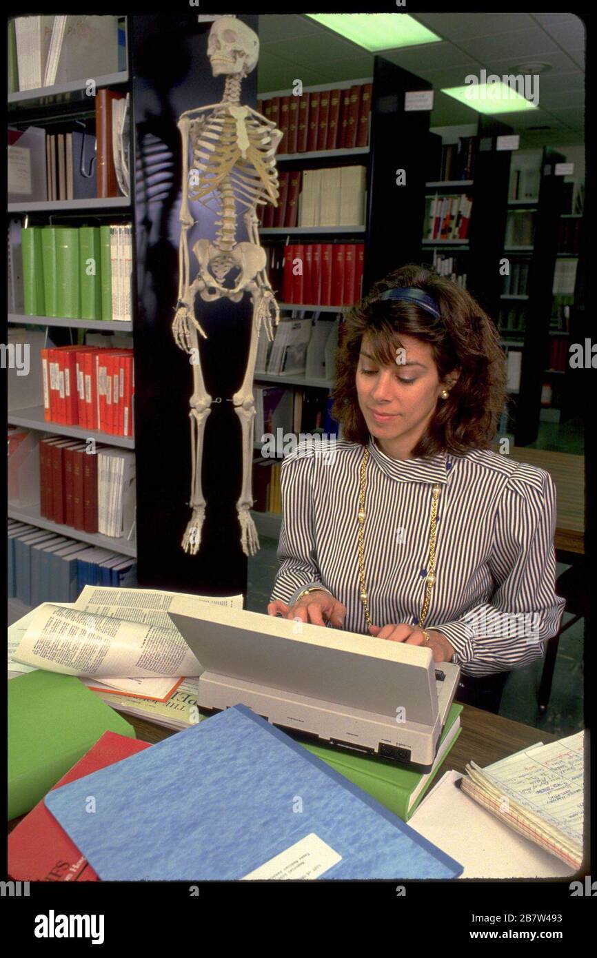 Austin Texas USA: La scrittrice medica femminile che digita sul computer portatile in biblioteca medica. SIGNOR ©Bob Daemmrich Foto Stock