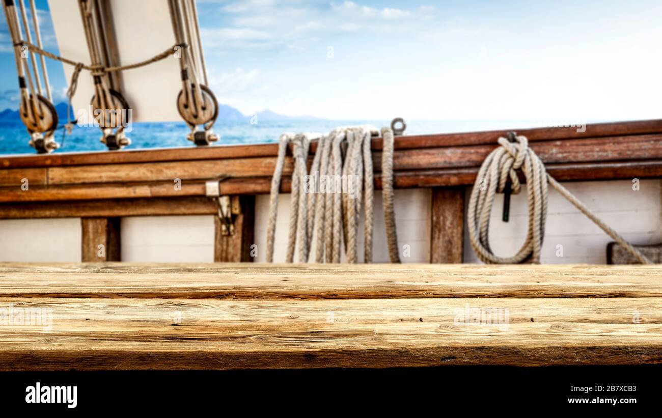 Vecchio sfondo tavolo in legno e spazio per la vostra decorazione. Vecchia nave e oceano sfondo paesaggio. Foto Stock