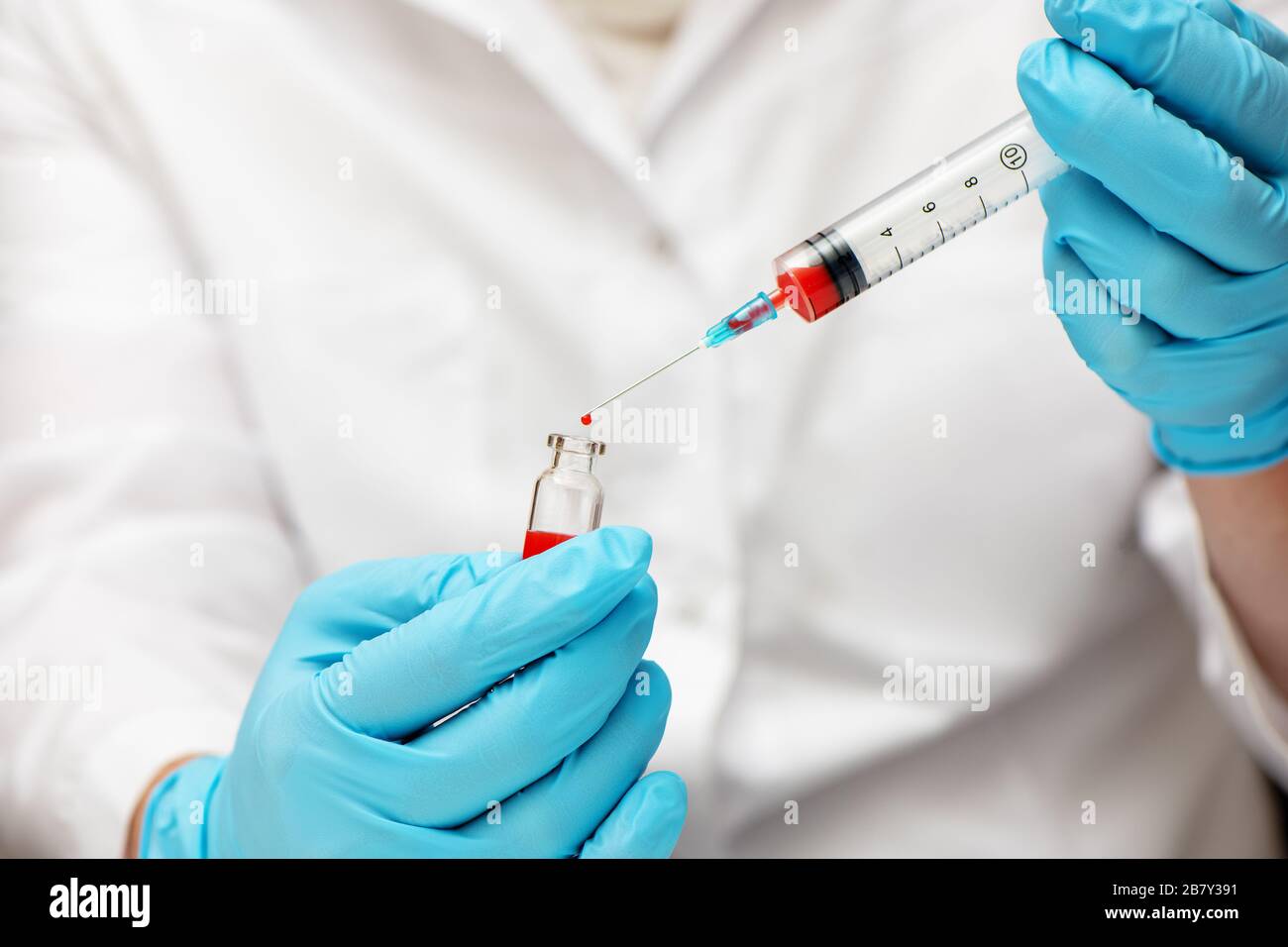 Medico nei guanti per uso medico che inietta il vaccino nella siringa. Concetto Coronavirus nCov 2019. Foto Stock