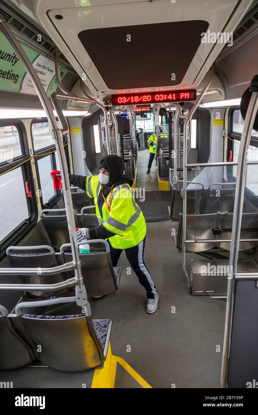 Detroit, Michigan, Stati Uniti. 18 Marzo 2020. I lavoratori disinfettano un autobus urbano tra una corsa e l'altra per proteggere contro il coronavirus Covid-19. Le pulizie sono il risultato di uno sciopero di un giorno da parte di autisti di autobus, membri della Amalgamated Transit Union Local 26. Credit: Jim West/Alamy Live News Foto Stock