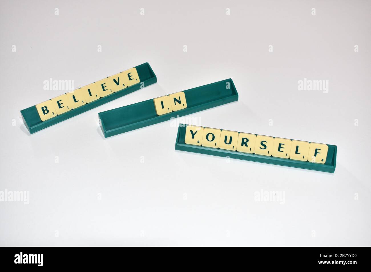 Le mattonelle Scrabble spell out credere in te stesso. Citazione motivazionale blocchi Scrabble lettere Grigio sfondo citazione di vita indurre alfabeto. Foto Stock