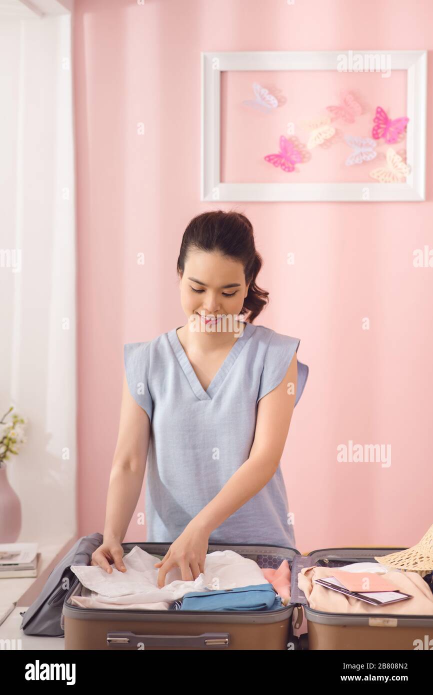 Donna di imballaggio a mano un bagaglio per un nuovo viaggio e viaggio per un lungo weekend Foto Stock
