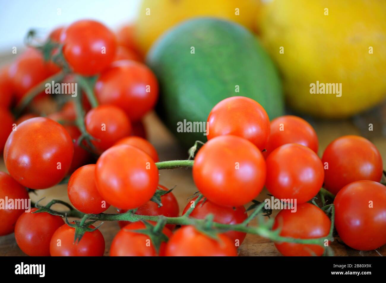 Pomodori ciliegini su tavola di legno. Foto Stock