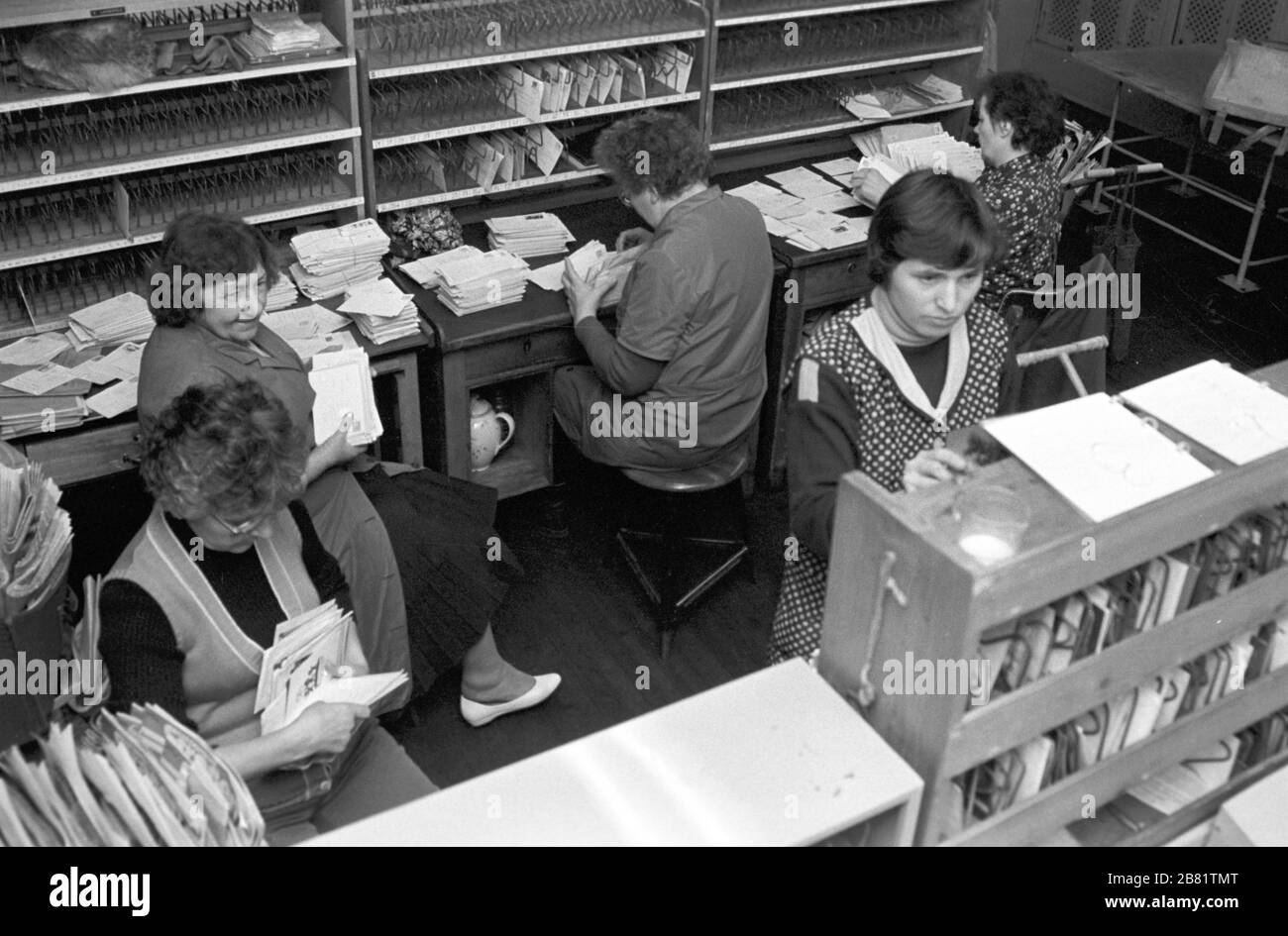 30 novembre 1988, Sassonia, Torgau: Le lettere e le carte sono ordinate da donne in un ufficio postale di Torgau della posta tedesca della RDT nel 1989. Data esatta di registrazione non nota. Foto: Volkmar Heinz/dpa-Zentralbild/ZB Foto Stock