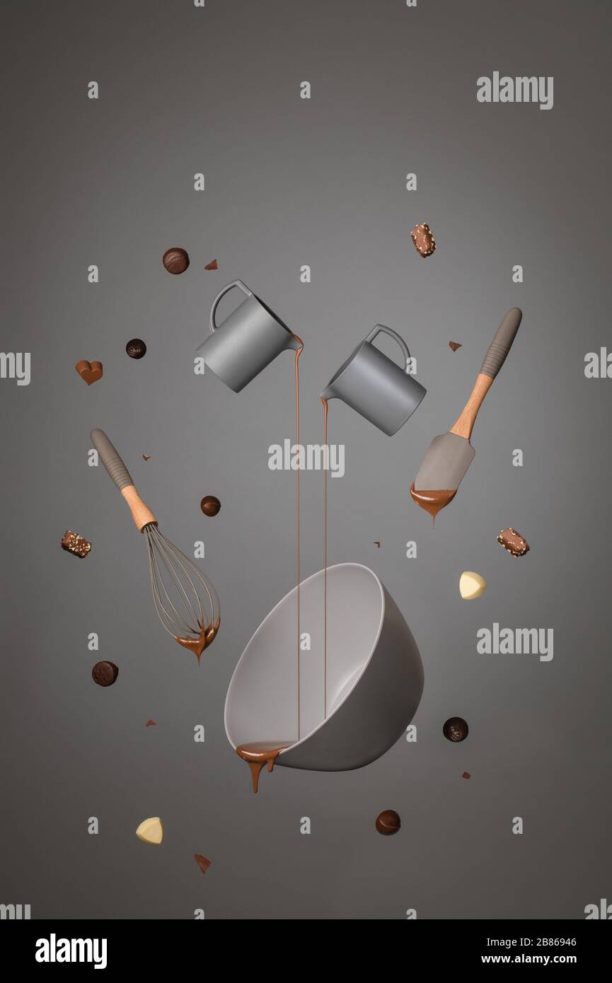 Colata di cioccolato fuso dalle caraffe in una ciotola come vari cioccolatini, una frusta e una spatola sono intorno al pour. Girato su uno sfondo grigio. Foto Stock