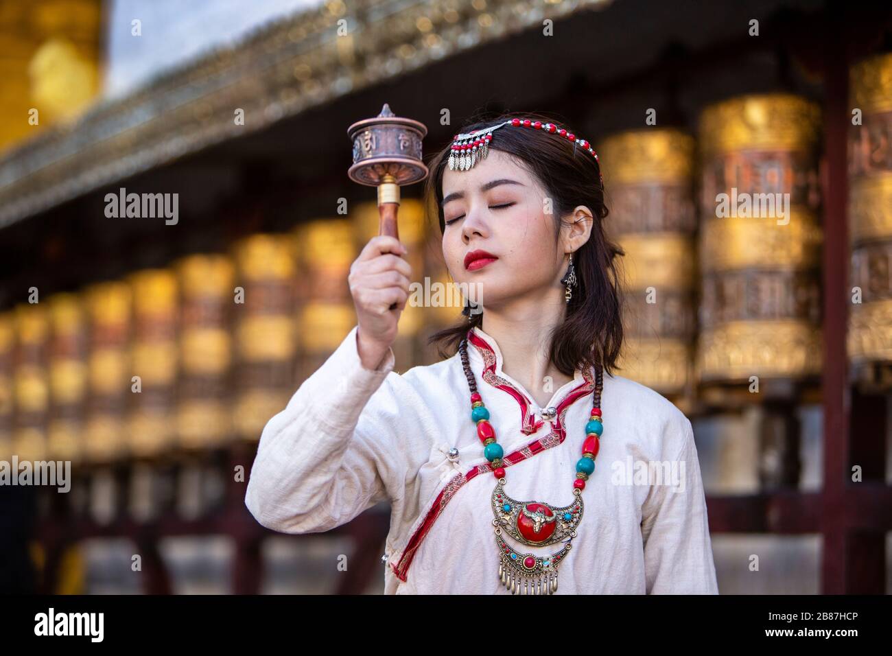 Ruota di preghiera girl tibetana a Barkhor, Lhasa, Tibet Foto Stock