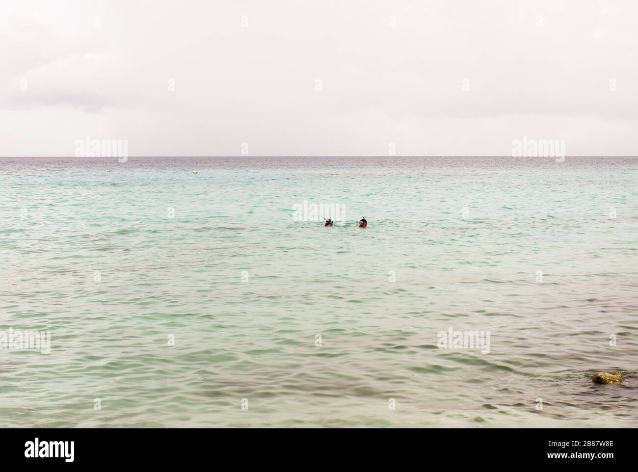 Mare tropicale con due persone per lo snorkeling in lontananza a Curacao Foto Stock