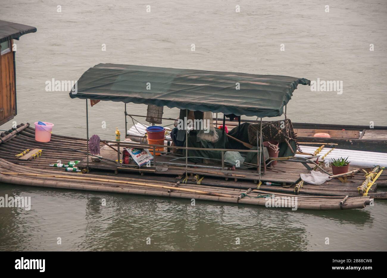 Guilin, Cina - 11 maggio 2010: Centro città. Closeup di Migrant operaio alloggio costruito su zattere sul fiume verdastro li. Foto Stock