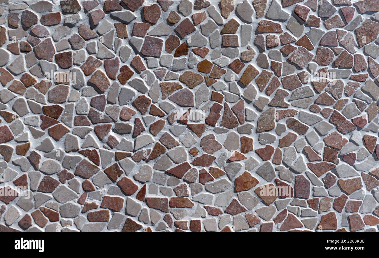 Particolare di un muro artificiale in pietra fabbricato industrialmente Foto Stock