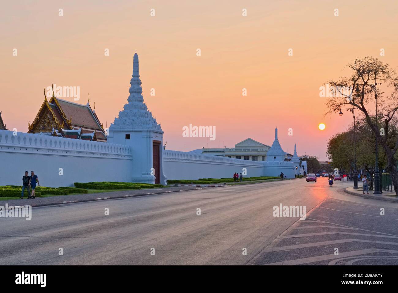 Tramonto su Na Phra LAN Rd. Lungo la parete nord di Wat Phra Kaew e Grand Palace, l'attrazione turistica più popolare di Bangkok, Thailandia Foto Stock