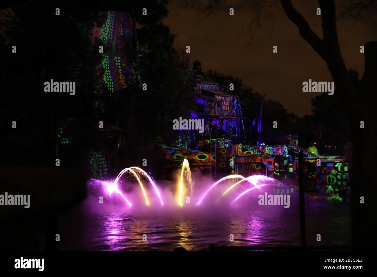 Luci colorate sull'acqua nel parco a tema di notte e altri oggetti per l'intrattenimento di ospiti paganti in Anaheim California colore concetti sfondi Foto Stock