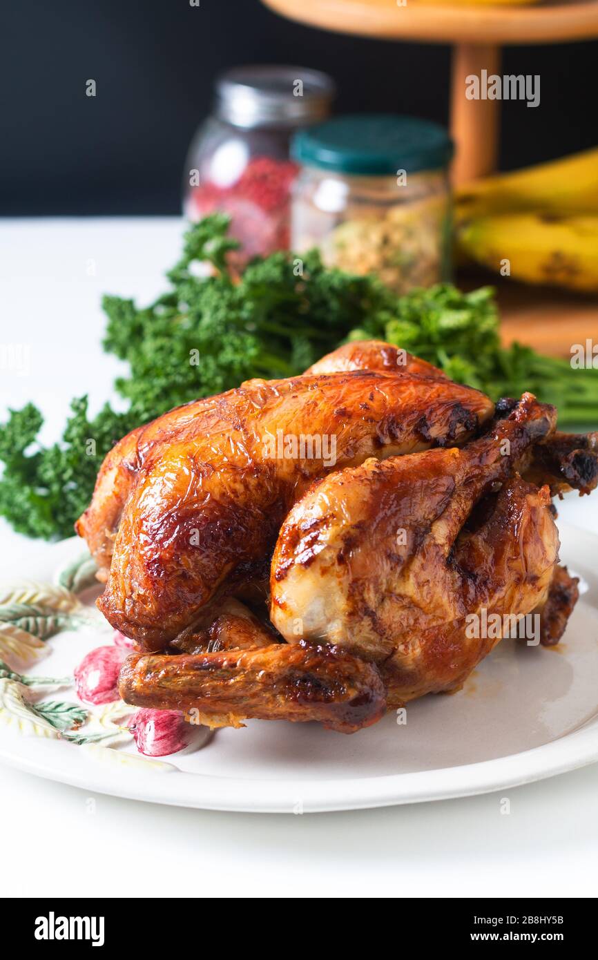 Concetto di cibo fatto in casa arrosto, grigliato di pollo organico intero su piastra di ceramica bianca Foto Stock