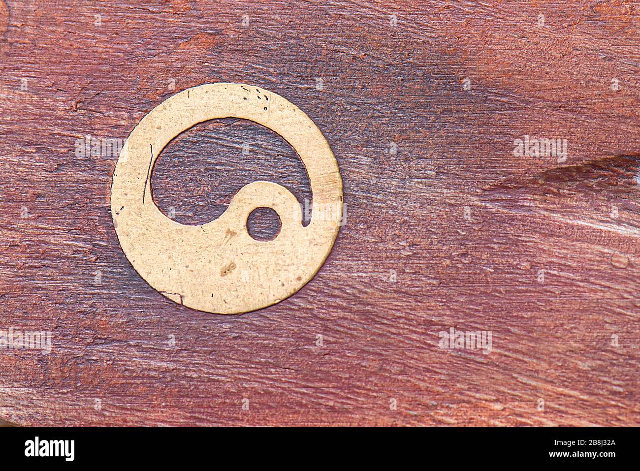 Yin e yang simbolo vintage ferro su superficie di legno Foto Stock