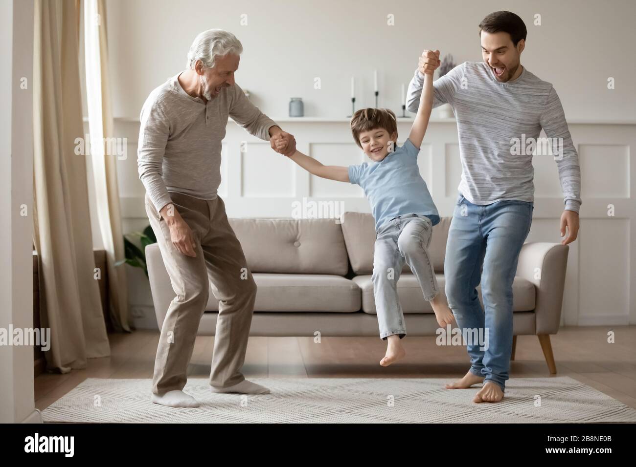 Buon bambino divertirsi con papà e nonno Foto Stock