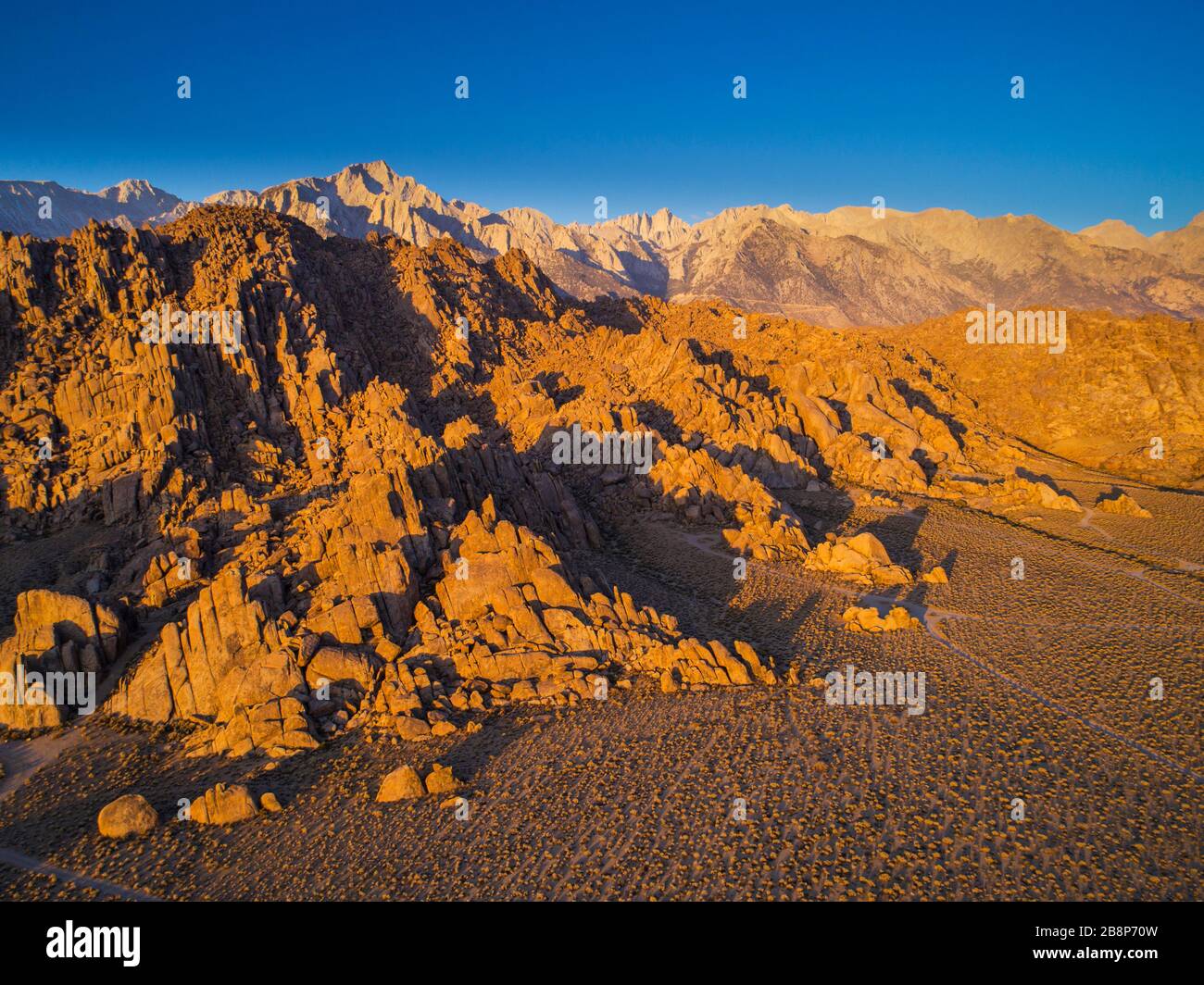 Vista aerea delle formazioni rocciose delle colline dell'Alabama con il Monte Whitney e la Sierra Nevada Mountains in lontananza. Foto Stock