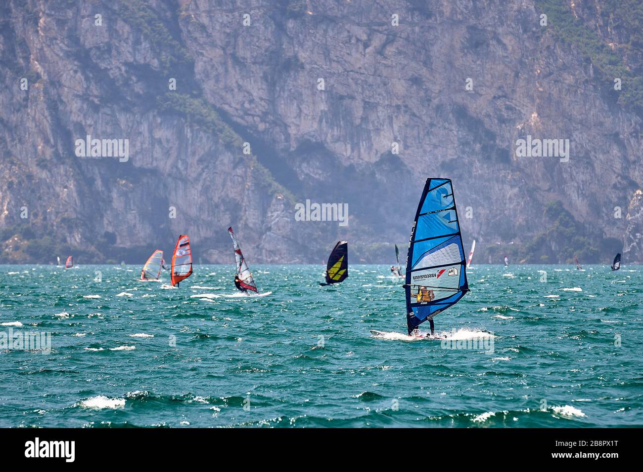 Riva del Garda,Lago di Garda ,Italia - 12 Giugno 2018: Windsurf surf il vento sulle onde nel Lago di Garda, rrider surf ad alta velocità sul Lago di Garda, R. Foto Stock