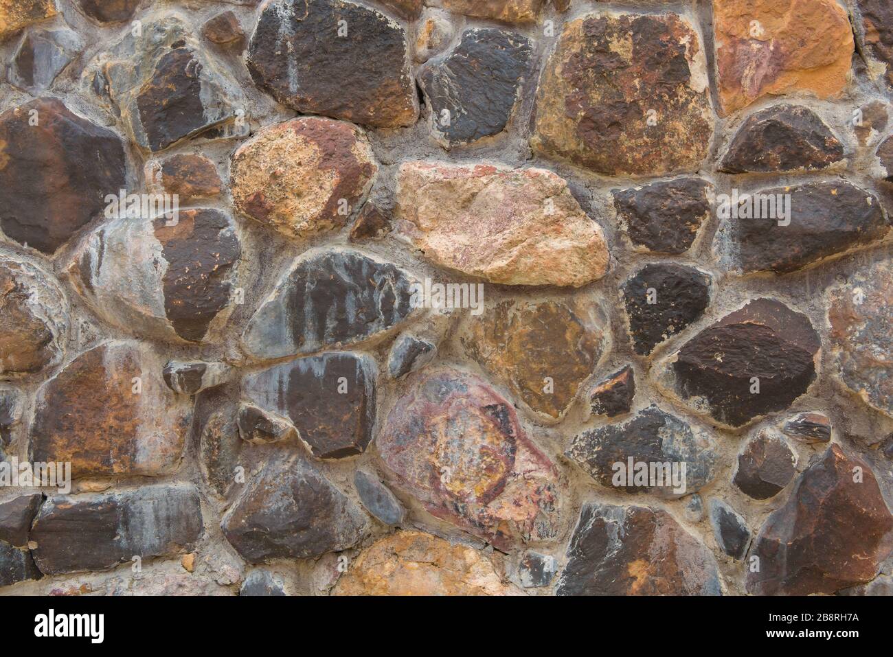 Sullo sfondo di un muro di pietra astratta di tessitura per la progettazione. Foto Stock