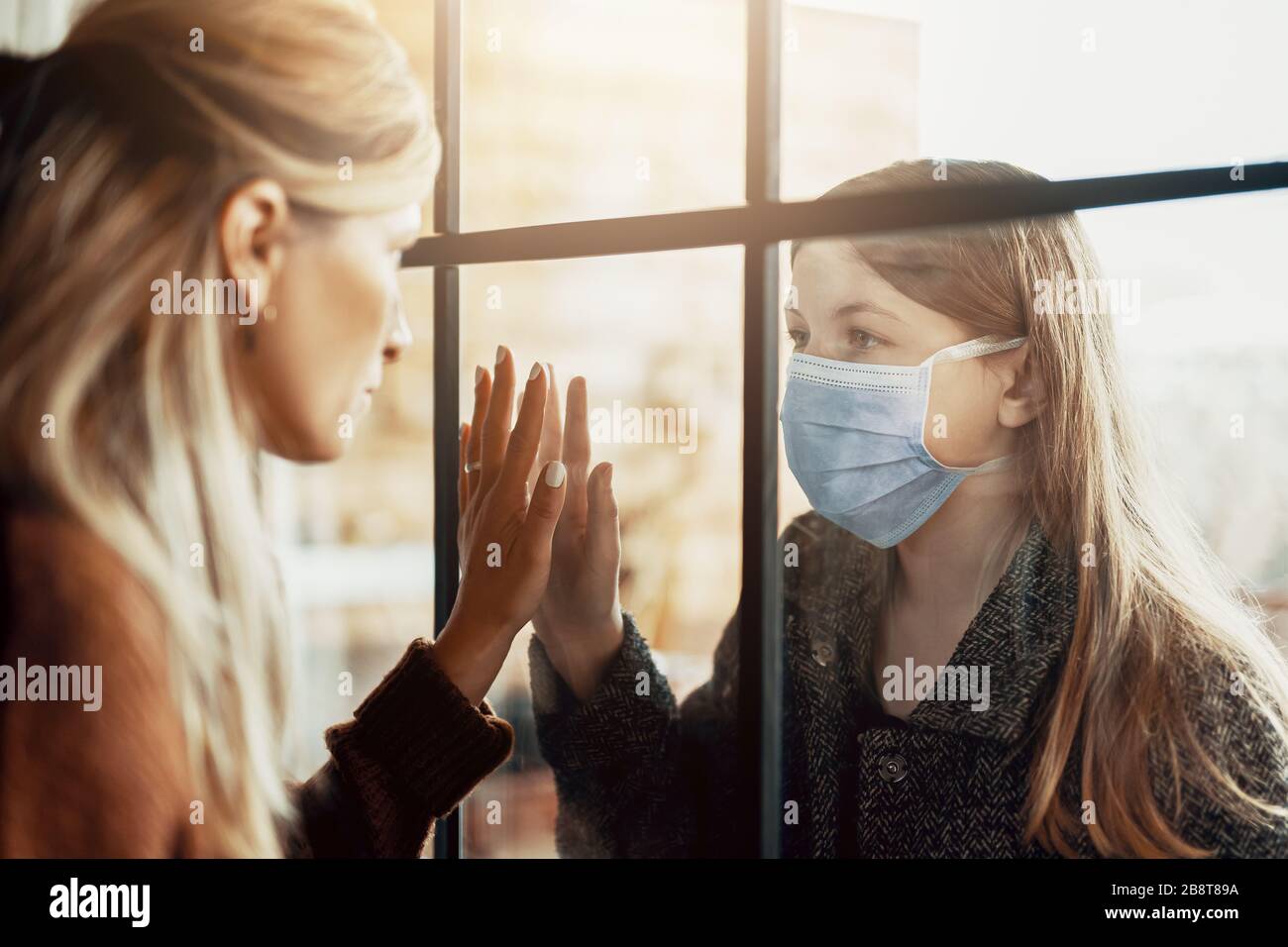 Madre e figlia sono separate a causa della quarantena Corona Virus Covid-19, sociale di distanza Foto Stock