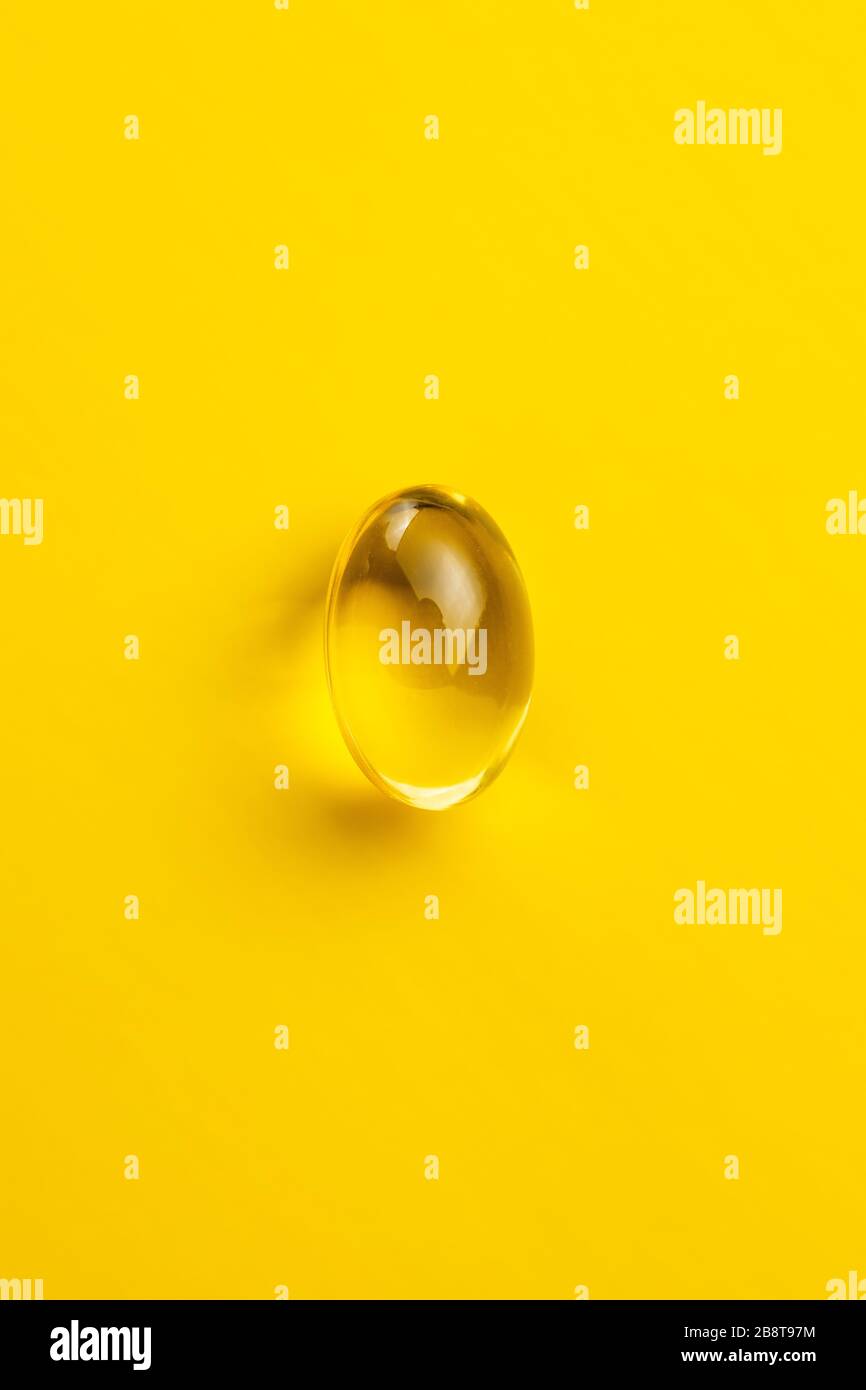 Omega 3 pillole. Capsule di supplemento di olio di pesce su sfondo giallo. Vista dall'alto. Foto Stock