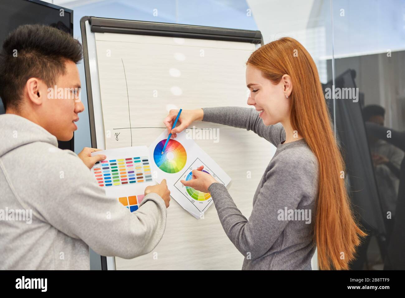 Il team creativo dell'agenzia di progettazione discute un'idea per il design dei colori di un sito web Foto Stock