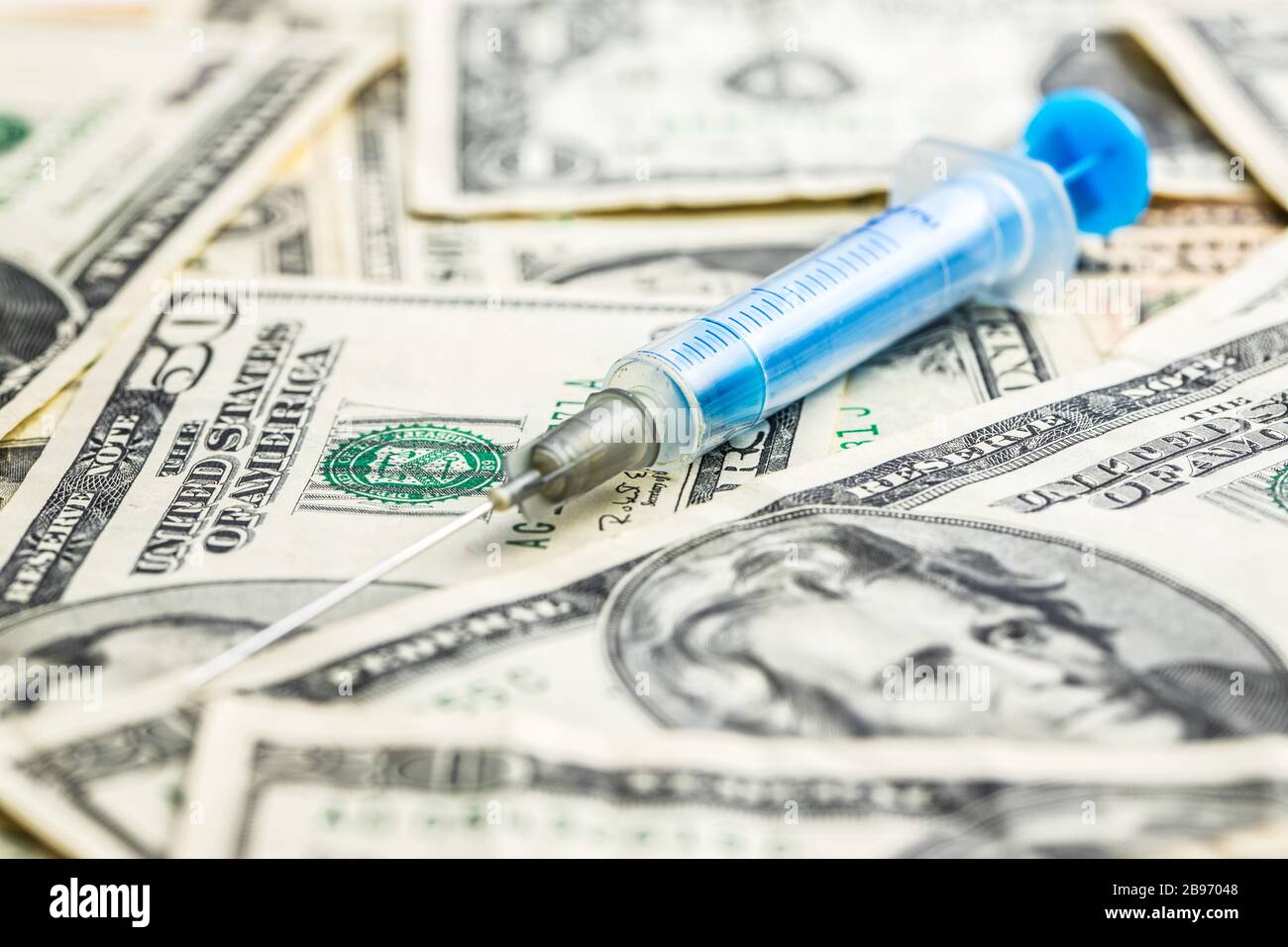 Siringa e dollari usa denaro. Concetto sanitario e aziendale. Foto Stock