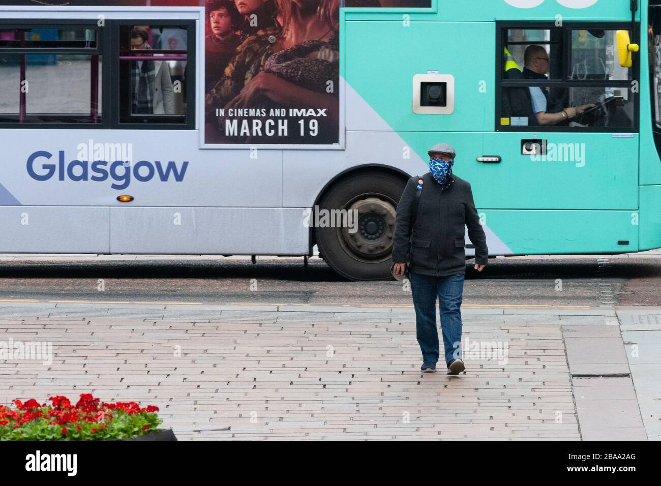 Glasgow, Scozia, Regno Unito. 26 marzo 2020. Coronavirus Lockdown Glasgow, Scozia: Un uomo con indipendenza scozzese protezione del viso passeggiate attraverso un centro di Glasgow molto tranquillo Credit: Kay Roxby/Alamy Live News Foto Stock