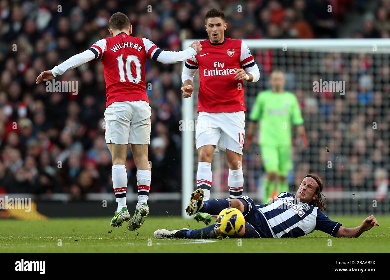 Jack Wilshere dell'Arsenal salta per evitare un'azione da Jonas Olsson di West Bromwich Albion Foto Stock