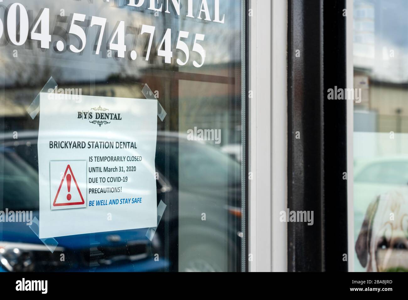 Surrey, Canada - 25 marzo 2020: Cartello sulla porta anteriore dell'ufficio dentale che annuncia la chiusura durante la pandemia di Coronavirus Foto Stock