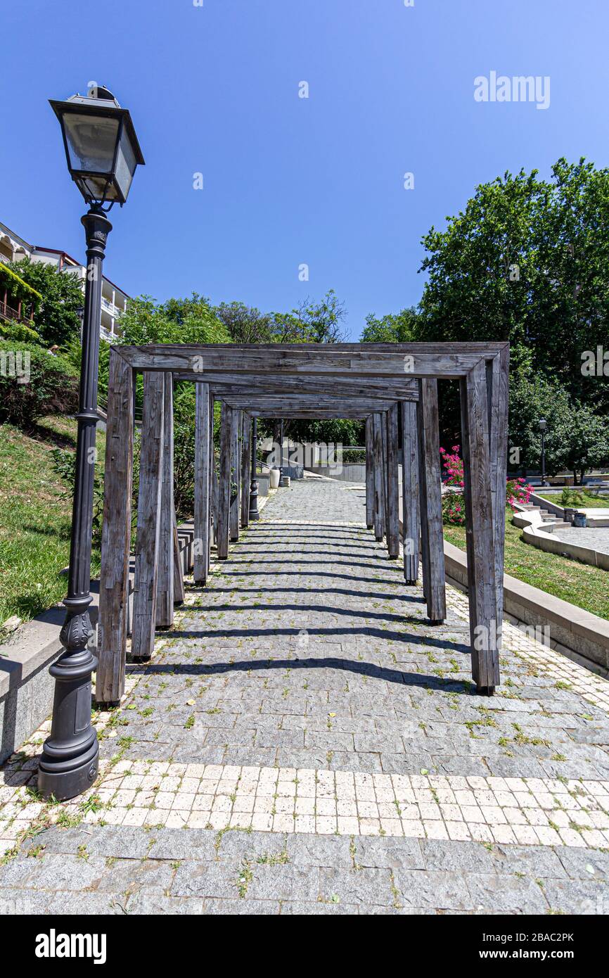 Serie di archi in legno che coprono un marciapiede in ciottoli a Tblisi, Georgia Foto Stock
