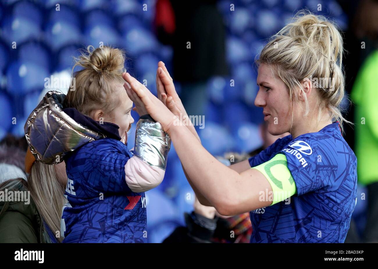 Millie Bright, donna di Chelsea, saluta un giovane fan negli stand dopo la partita Foto Stock