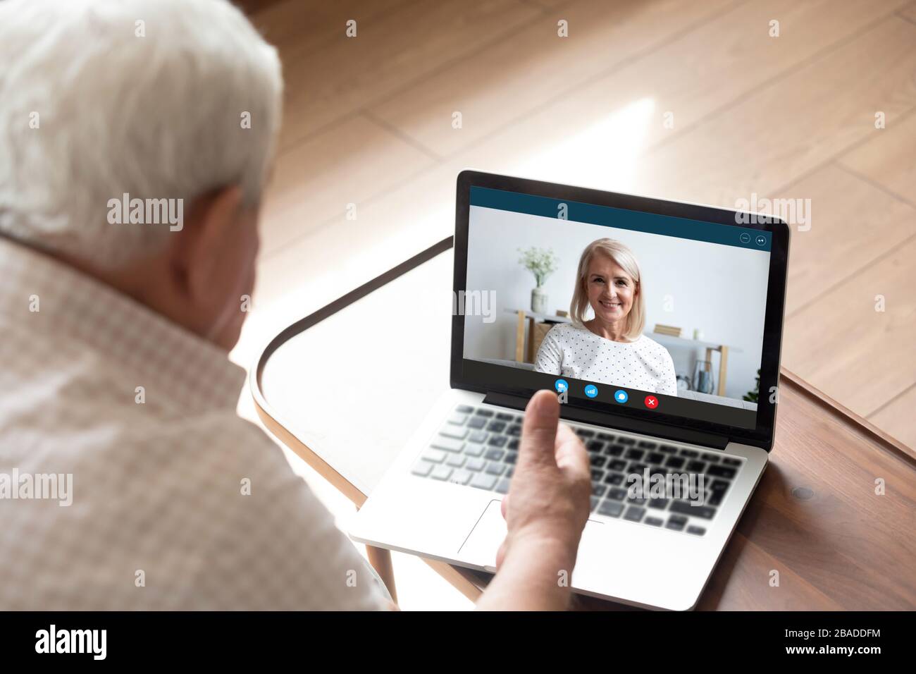 Felice donna di mezza età che chiacchiera con il marito del padre più anziano in linea. Foto Stock